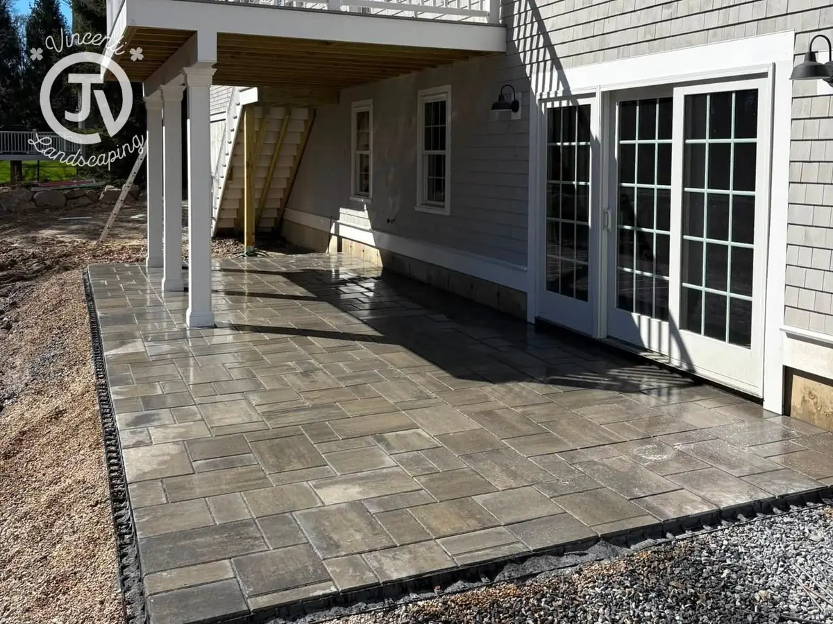 Paver patio under deck by Vincenti Landscaping