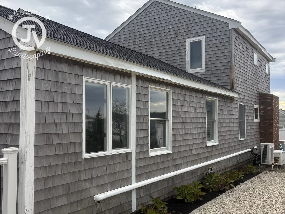 Foundation planting beds with new plantings and mulch installed by Vincenti Landscaping in Marshfield, MA