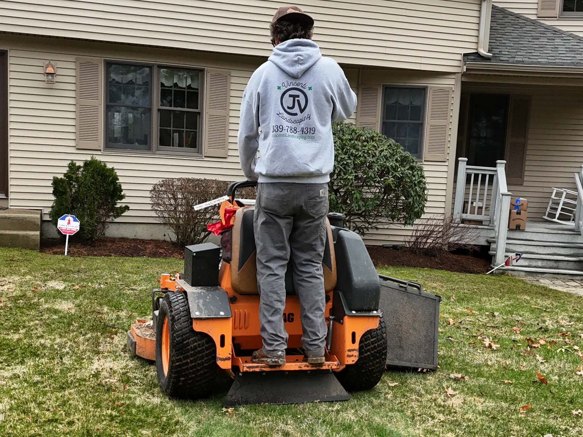 Vincenti Landscaping crew mowing a South Shore lawn