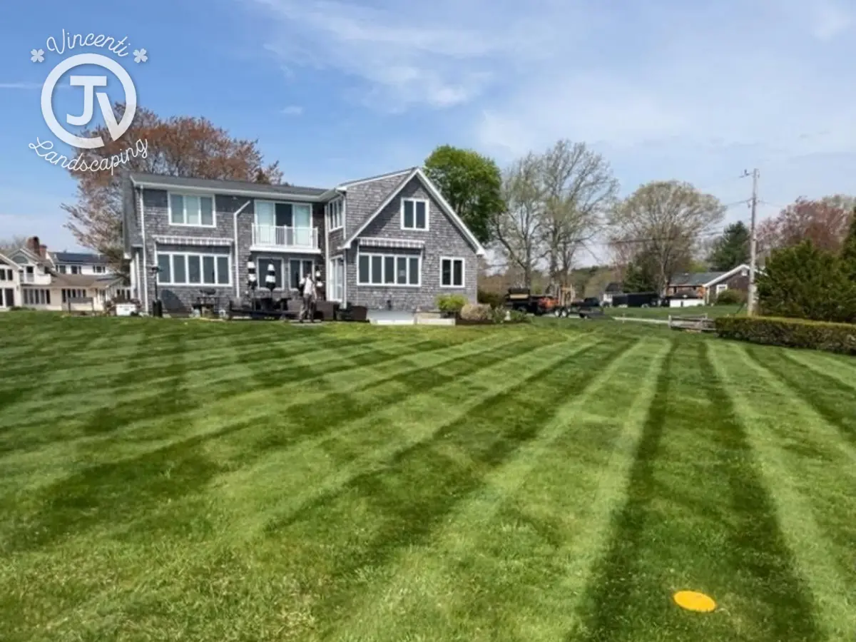 Striped lawn after weekly mowing by Vincenti Landscaping